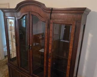 Elegant Vintage Wooden China Cabinet β Glass Display Hutch Beautiful, oversized wooden china cabinet featuring a rich dark wood finish, decorative crown molding, glass-paneled display doors, and lower enclosed storage compartments. The traditional design offers plenty of room to showcase fine china, glassware, collectibles, books, or treasured dΓ©cor. Its classic silhouette and substantial construction make it a statement furniture piece for a dining room, living room, or vintage-inspired home. Features: β’ Glass display doors β’ Interior display shelving β’ Decorative crown molding β’ Lower cabinet storage β’ Traditional dark wood finish Condition: Pre-owned with age-appropriate wear.