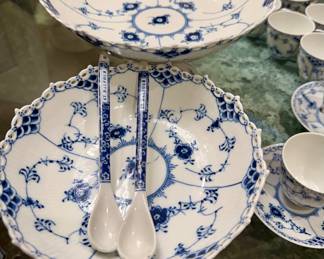 This is Royal Copenhagen Blue Fluted Full Lace porcelain dinnerware, featuring hand-painted blue floral and vine motifs with openwork lace borders.