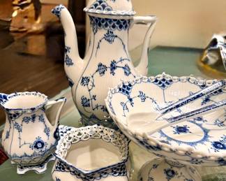 This is Royal Copenhagen Blue Fluted Full Lace porcelain dinnerware, featuring hand-painted blue floral and vine motifs with openwork lace borders.