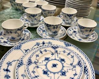This is Royal Copenhagen Blue Fluted Full Lace porcelain dinnerware, featuring hand-painted blue floral and vine motifs with openwork lace borders.
