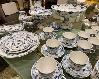 This is Royal Copenhagen Blue Fluted Full Lace porcelain dinnerware, featuring hand-painted blue floral and vine motifs with openwork lace borders.