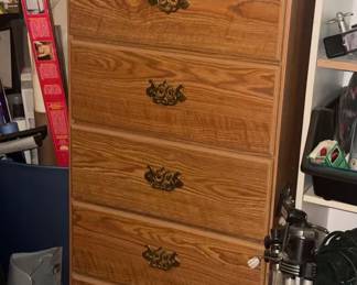 Beautiful, traditional solid oak 5-drawer tallboy dresser. Features gorgeous natural wood grain finish and elegant, ornate brass pull handles on each drawer. Drawers track smoothly and offer deep, ample storage space for clothes or linens. Very sturdy, high-quality furniture piece in excellent shape