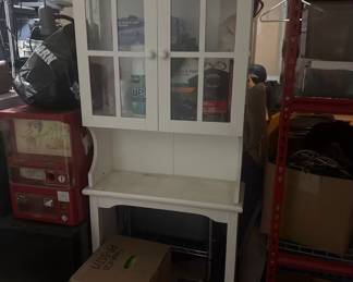 Charming, solid wood white hutch cabinet perfect for a kitchen, dining room, or craft area. Features a top display unit with two classic window pane glass doors and interior shelving. Includes a spacious open counter area and an open bottom storage shelf base. Clean, bright, and ready for a new home