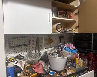supplies, including a brand-new Ridgid shop vac filter, Hoover cartridge filters, adjustable wrenches, electrical multimeters, a pegboard organizer, and storage buckets filled with assorted nuts, bolts, and hardware