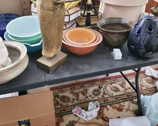A great assortment of vintage home goods and collectibles. Includes a nested set of vintage primary/pastel color mixing bowls (including turquoise and peach shades), a stunning metallic gold Art Deco-style female torso statue on a solid block base, an inverted glass shade lamp, and a classic ceramic table lamp base with a large neutral beige shade
