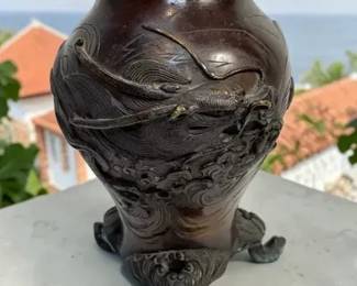 Cast metal three footed vase