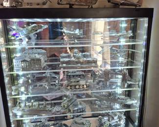 Collection of intricate metal models and display cabinet