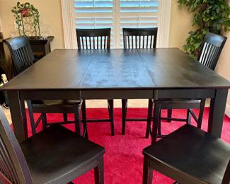 Counter-height extendable dining table with 6 chairs. Measures 54" x 54" with leaf