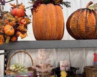 Fall decor: large faux pumpkins, harvest arrangements, and wreaths.