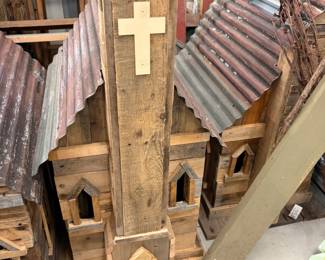 Handmade rustic church birdhouses with tin roofs.