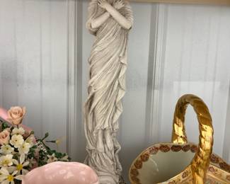 Figurine, pink vase, and gold basket.
