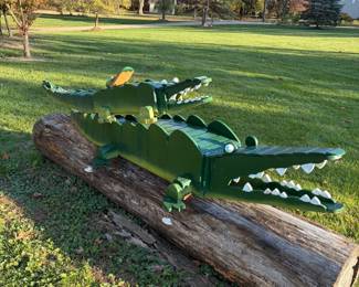 Giant handmade wooden yard crocs with painted teeth and eyes. One of a kind yard art.