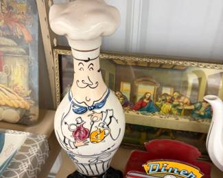 Chef decanter, Last Supper print, and teapot.