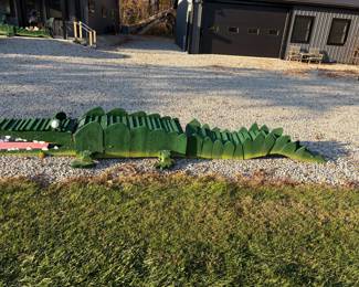 Giant handmade wooden yard crocs with painted teeth and eyes. One of a kind yard art.