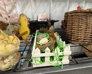 Easter and spring decor: ceramic chicks and ducks, baskets, and faux florals.