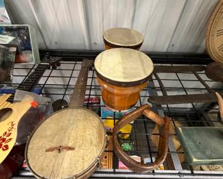 Hand-painted ukuleles, banjo, and bongo drums.