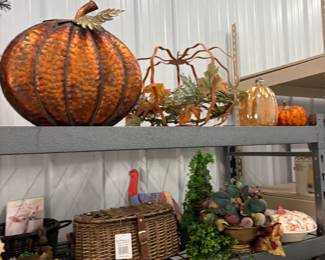 Fall decor: large faux pumpkins, harvest arrangements, and wreaths.