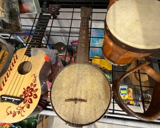 Hand-painted ukuleles, banjo, and bongo drums.