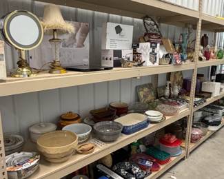 Shelves of housewares, cookware, bowls, and a vanity mirror.