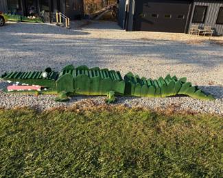 Giant handmade wooden yard crocs with painted teeth and eyes. One of a kind yard art.