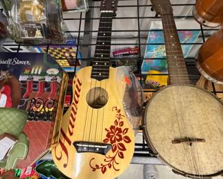 Hand-painted ukuleles, banjo, and bongo drums.