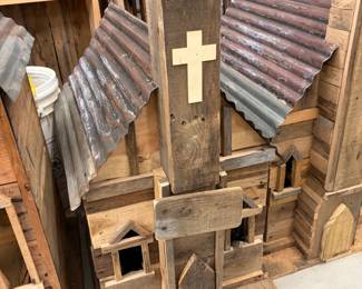 Handmade rustic church birdhouses with tin roofs.