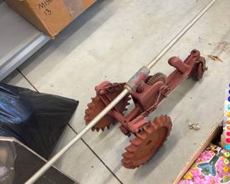 Vintage red metal hand cultivator.