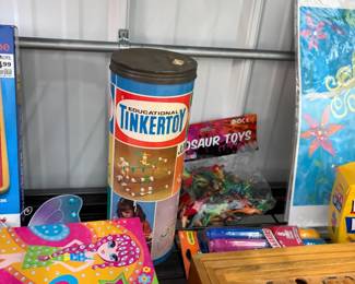 Vintage toys: Tinkertoy canister, dinosaur toys, and games.