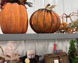 Fall decor: large faux pumpkins, harvest arrangements, and wreaths.