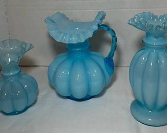 Fenton Blue Overlay Melon Rib Pitcher, Bud Vase and Footed Vase - A Fenton blue overlay melon rib pitcher with an applied blue handle, a ruffled bud vase, and a tall footed vase with a ruffled top. A good lot for blue glass collectors.