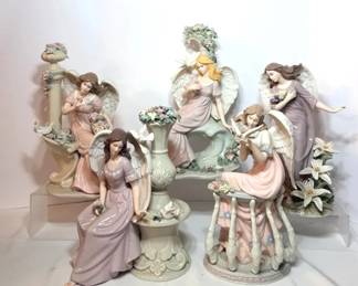 Lavender and Pink Porcelain Angel Figurines with Roses and Lilies - Five pastel angel figurines with roses, lily blooms, garden columns, and a floral urn. A good lot for angel collectors.