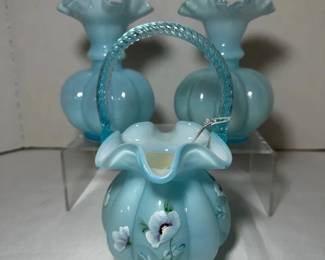 Fenton Blue Overlay Hand Painted Basket and Two Ruffled Vases - A Fenton blue overlay basket with a twisted blue handle, ruffled rim, and hand painted purple and white flowers, shown with two matching ruffled melon rib vases. A good set for Fenton collectors.