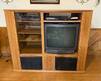 Oak Entertainment Center with Sony Trinitron TV, Magnavox DVD Recorder and VCR - An oak entertainment center with glass doors, open shelves, and speaker bays, shown with a Sony Trinitron tube TV, a Magnavox DVD recorder with remote, and a VCR. A good piece for a retro setup.