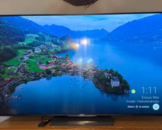 Sony Flat Screen TV - A Sony flat screen TV with a remote, shown with its Google TV home screen. A good pick for a bedroom or den.