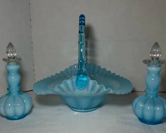 Fenton Blue Overlay Basket with Pair of Stoppered Perfume Bottles - A large Fenton blue overlay basket with a ruffled edge and twisted blue handle, shown with two matching perfume bottles with clear stoppers. A great grouping for Fenton collectors.