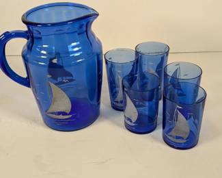 Lot 230: Cobalt blue glass set with sailboat design