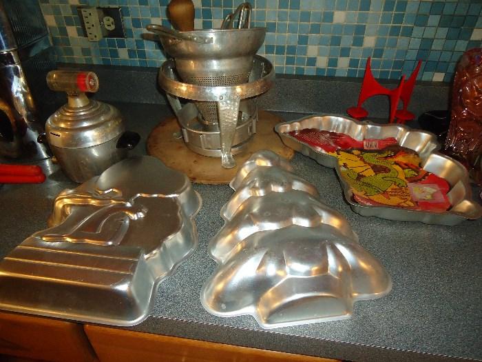 Quite a few Wilton pans plus cookie cutters and lots of baking items