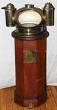 Lot#4,HENRY HUGHES & SONS BRASS AND WOOD BINNACLE AND COMPASS, C1900, H 43"Husun compass binnacle by Henry Hughes & Sons, having an octagonal shape, brass compass housing with functional floating compass card and oil illuminating lamps on each side in cylindrical brass cases, Henry Hughes mfg. plate on front of binnacle.