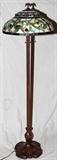 Lot#305, MEYDA TIFFANY STYLE LEADED GLASS, FLOOR LAMP, H 57", DIA 18"Meyda Tiffany style floor lamp, having a jeweled cherry blossom style leaded glass shade with brass eagle finial. Bronze style metal base,