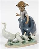 Lot#329, LLADRO, PORCELAIN FIGURINE, YOUNG GIRL WITH GEESE, H 7"depicts a young girl, mother goose and goslings, 7 1/4" H.