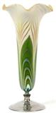 Lot#1002, STEUBEN DECORATED AURENE GLASS VASE WITH HAWKES STERLING BASE, H 11 1/4"Trumpet form alabaster and gold aurene glass vase with ruffled rim and pulled feather motif in green and silver, raised on a Hawkes sterling silver base.