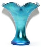 Lot#1017, STEUBEN BLUE AURENE GLASS VASE, H 9 1/2", DIA 9": Trumpet form with ruffled rim.  Signed "Aurene 723" (see additional photo).  Reference: "The Glass of Frederick Carder", Paul V. Gardner, copyright 1971, Crown Publishers, New York, catalog line number 723 (p.255).  Early 20th century. Good condition. Jw