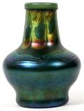 Lot#1061,L. C. TIFFANY BLUE FAVRILE GLASS VASE, C. 1900, H 7 1/4", DIA 5 1/2"Blue Favrile glass with pulled scroll motif about the neck, shoulder and base.  Signed "LCT M 7138" (see additional photo).