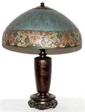 Lot#1075, HANDEL REVERSE PAINTED GLASS 'PERSIAN' LAMP, C. 1925, H 8", DIA 18"Domed chipped ice shade painted at the interior with a Persian border, signed "Handel 6637 F" at the interior rim (see additional photo), raised on a patinated metal base in the form of a Japanese baluster vase with birds and prunus blossoms in low relief, the foot molded to simulate a carved and pierced hardwood stand, not marked but by Handel.  For an example of the lamp base, see "Handel Lamps" by De Falco, Hibel and Hibel, copyright 1986, p.176.