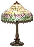 Lot#1077, HANDEL LEADED GLASS TABLE LAMP, EARLY 20TH C., H 25", DIA 18"Pansy motif in shades of purple, green and caramel, signed "Handel" at the interior, the patinated metal base also signed "Handel" (see additional photos).