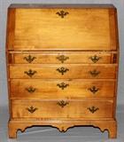 Lot#1129, AMERICAN CHERRY SLANT-FRONT DESK, C. 1800, H 43", W 37", D 19"In the Chippendale taste, the slant-front hinges open to compartmented interior, fitted with four drawers of graduated size above a scalloped apron, raised on bracket feet.