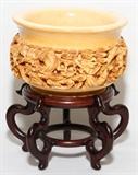 Lot#1242, CHINESE IVORY BOWL, H 3 1/4", DIA 5": Item to be sold in the USA only.  The exterior carved in relief, signed at the underside (see photo), raised on a wood base. Good condition jw