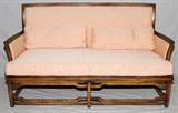 Lot#1335, HIBRITEN ORIENTAL STYLE UPHOLSTERED SETTEE, H 34", L 58": Salmon colored upholstery with two matching accent pillows.  Measures H.34" x 58" x 27". Fading to the upholstery noted.  JMF