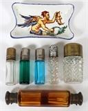 Lot#1373, CUT & COLORED GLASS SCENT BOTTLES (6), LATE 19TH-EARLY 20TH C., L 2 1/2"-5", & GIEN FAIENCE PIN TRAY: Scent bottles include 1 faceted amber glass, double-end; 1 cut glass with English sterling cap and collar (with stopper), Birmingham, 1911-12; 2 colorless, one of which with diamond cuts, 1 blue glass (with stopper) and 1 green glass, all with metal caps.  Together with 1 Gien, French faience pin tray, hand painted at the well with a satyr, L.4 1/4".  Seven items total. Very few, minor nicks to the cut glass due to handling; one cap of the amber bottle does not close securely, also lacking stoppers; three are stuck closed. Chs