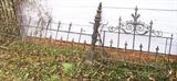 It is hard to really see what the fencing looks like, but there are 8 approximately 8 foot lengths of iron fencing, along with some posts